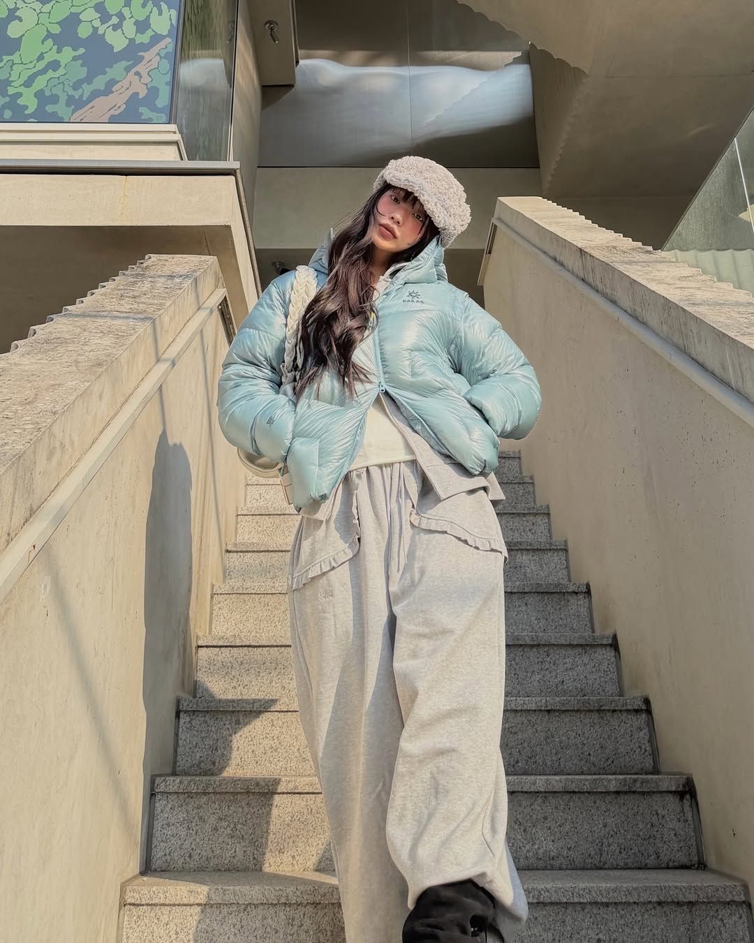 광택이 도는 하늘색 패딩으로 캐주얼한 겨울 룩을 완성한 설쁘 / @mulbada