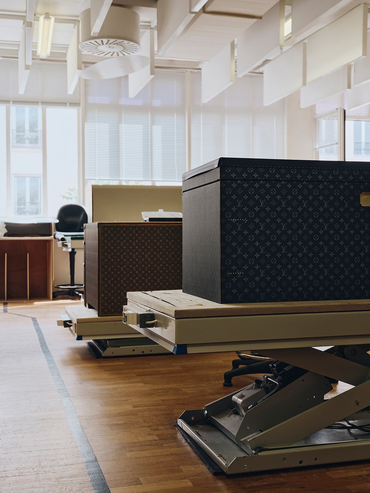 작업 중인 피스들이 놓인 워크숍과 트렁크가 전시된 갤러리 풍경.