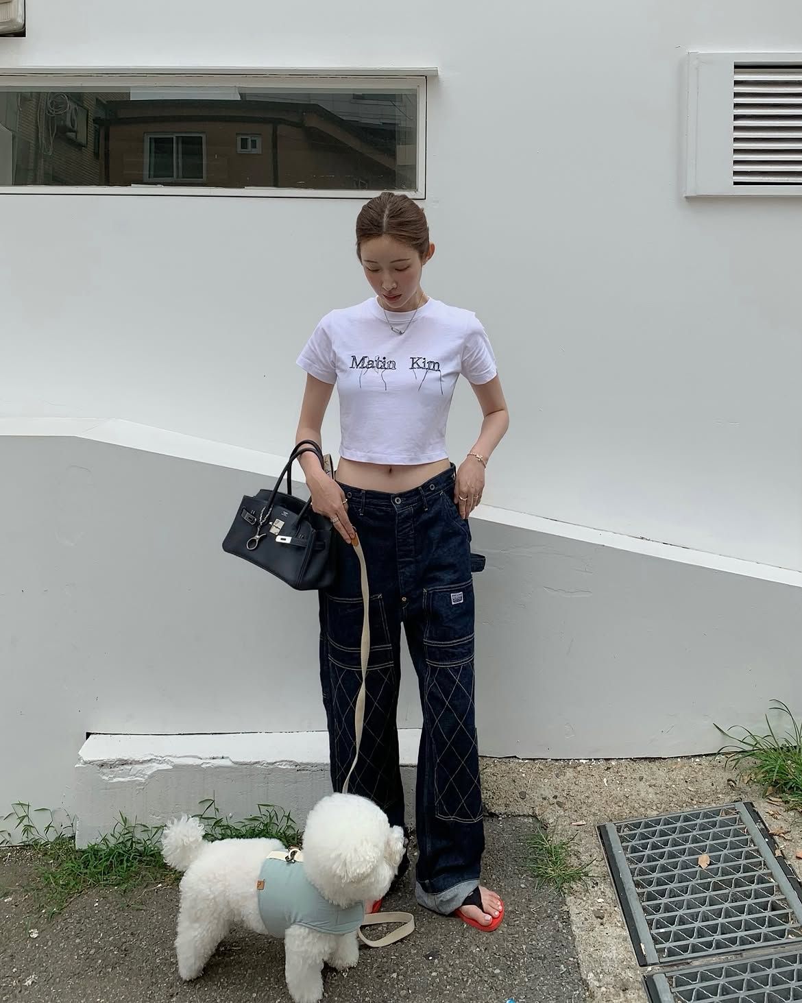 브랜드 로고가 있는 미니 티셔츠와 블랙 백을 매치해 미니멀한 여름 룩을 완성한 차정원 / @ch_amii
